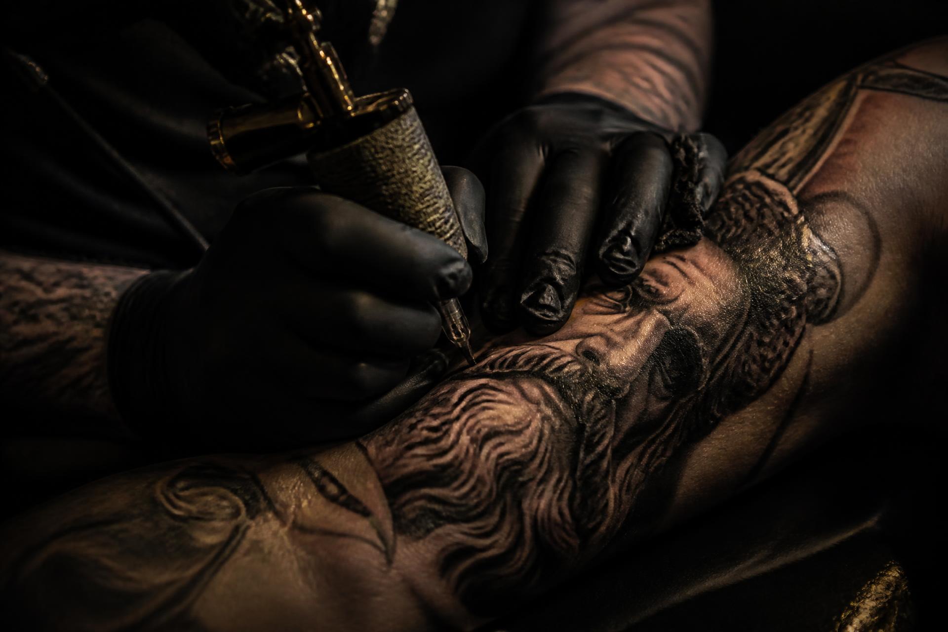 Close-up of black and grey realism tattoo work in progress